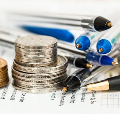 coins, pens and a financial plan